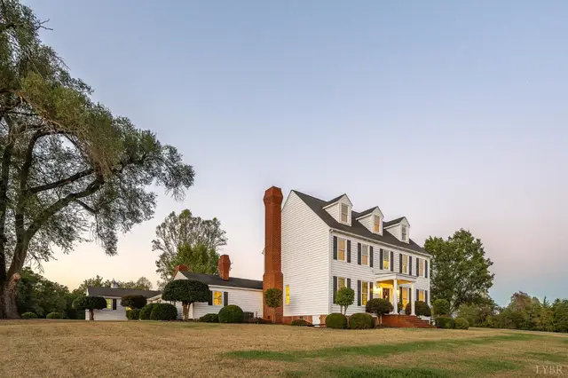 Side of the house with a brick chimney and dormers at 1351 Country Estates Drive, Lowry VA