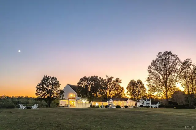 View of the house at sunset across an open lawn at 1351 Country Estates Drive, Lowry VA
