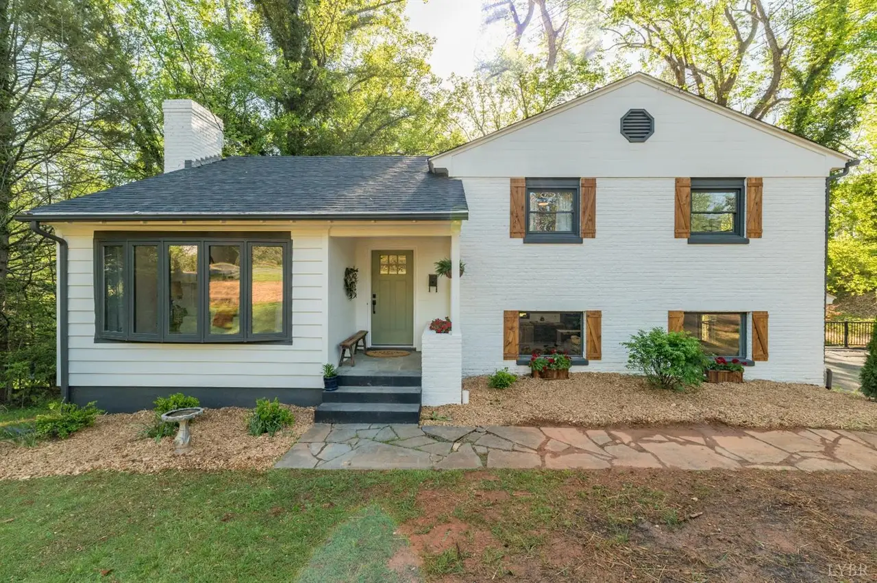 Front of the house, white split-level with brown shutters and a stone walkway at 1470 Langhorne Road, Lynchburg VA