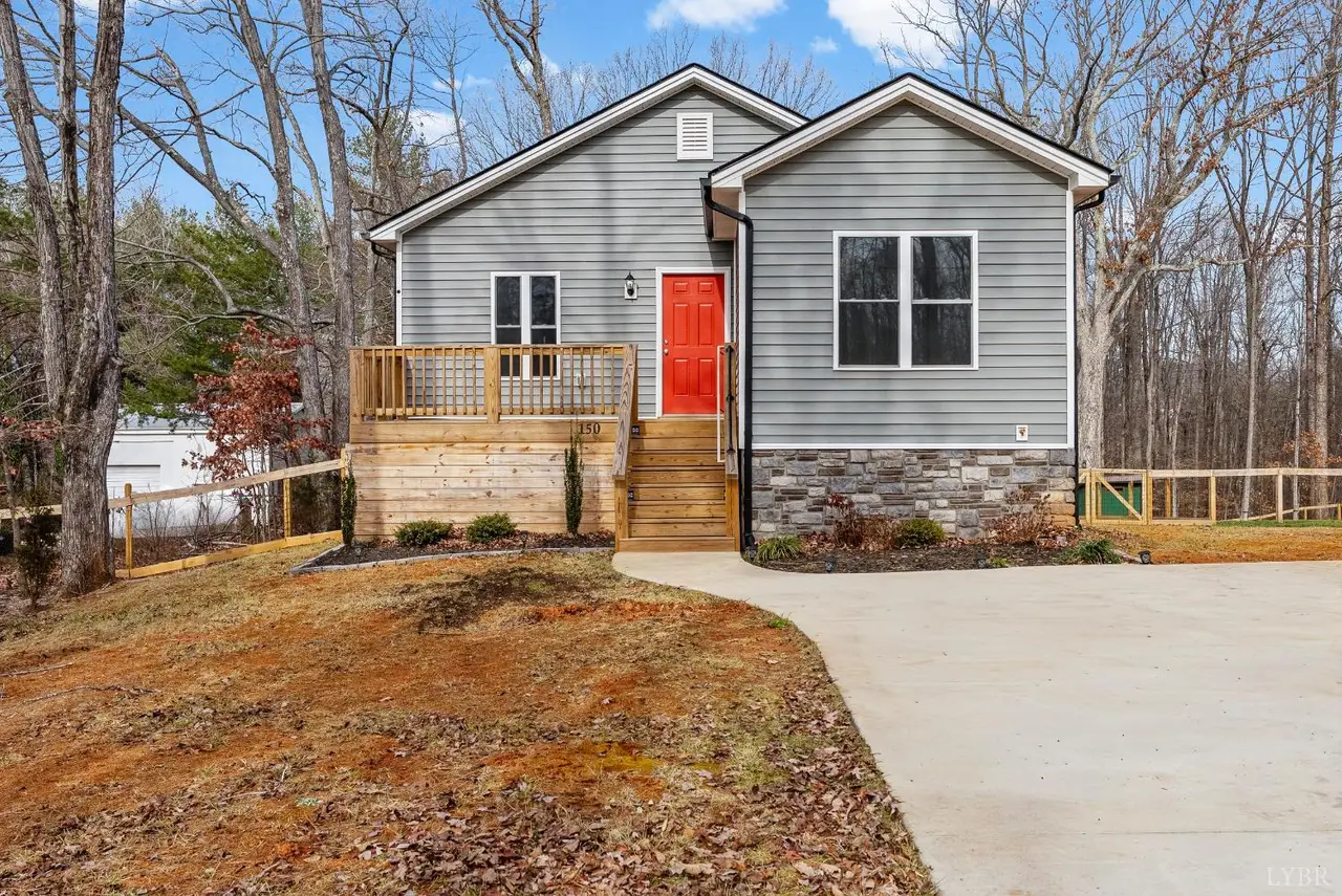 Front of the house with gray siding, a red front door and a wood deck at 150 Oak Grove Drive, Madison Heights VA