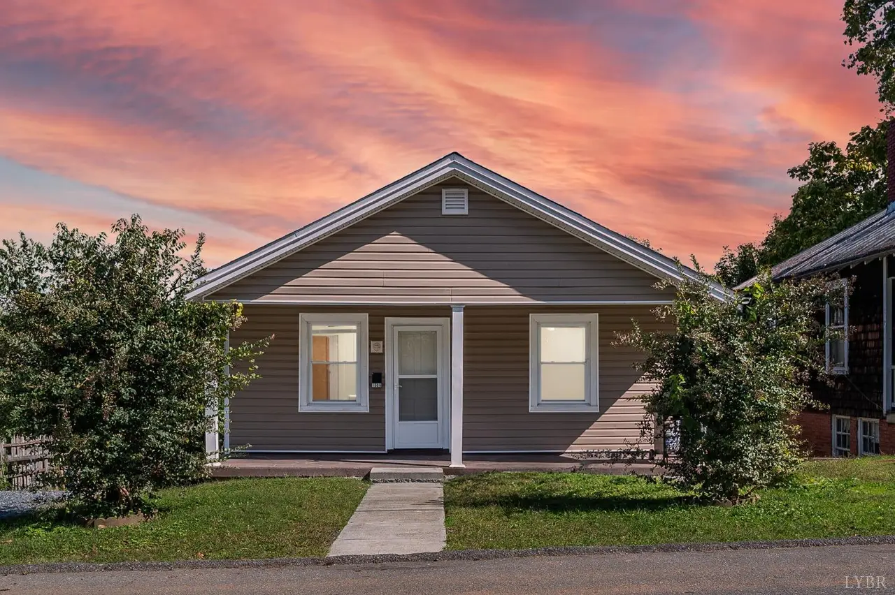Front of the house, one-story with tan siding at sunset at 1506 Monroe Street, Lynchburg VA