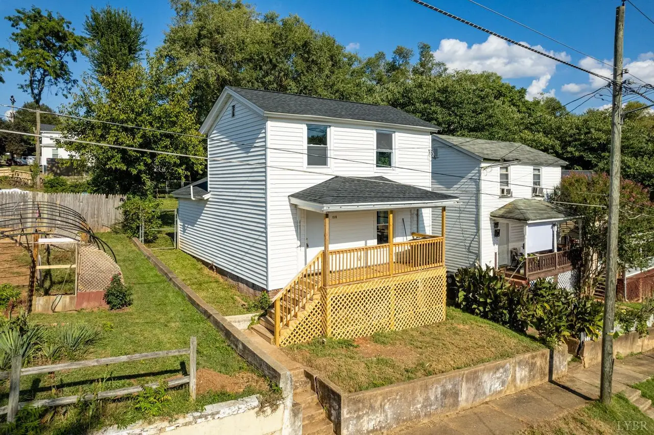 Side view of the white house with a wood porch and lattice skirting at 1510 Garfield Avenue, Lynchburg VA