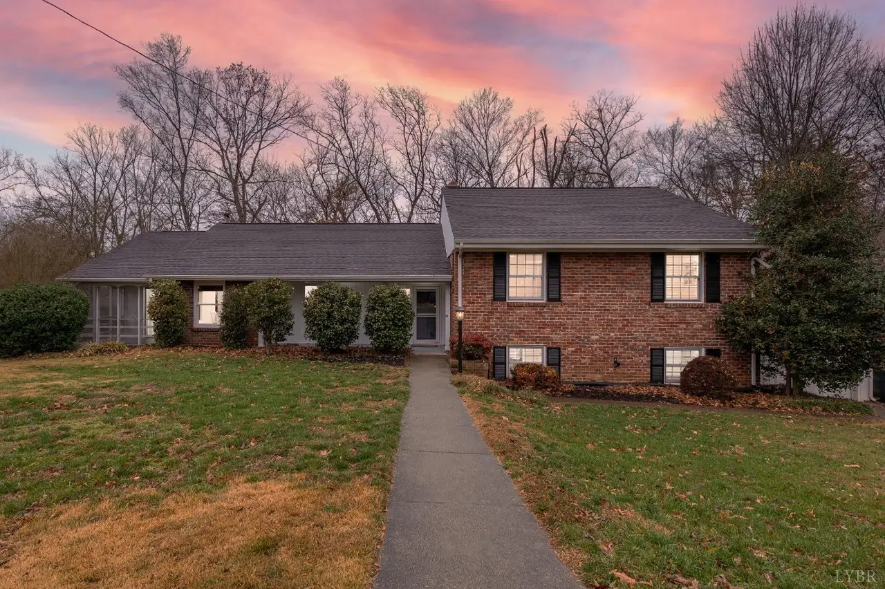 Front of the house, brick split-level with a long front walkway at sunset at 1519 Club Drive, Lynchburg VA