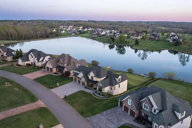 Aerial view of homes along the lake and a curving street at 1698 Lake Manor Drive, Forest VA