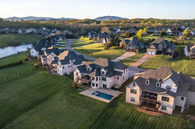 Aerial view of the neighborhood with a backyard pool and mountains at 1698 Lake Manor Drive, Forest VA
