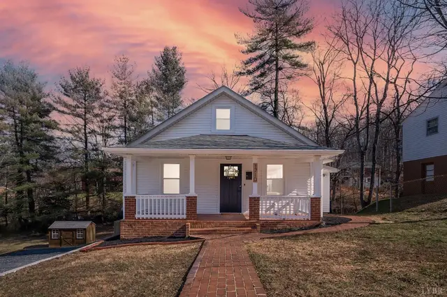 Front of the house with a covered porch and brick walkway at sunset at 1710 Texas Avenue, Lynchburg VA