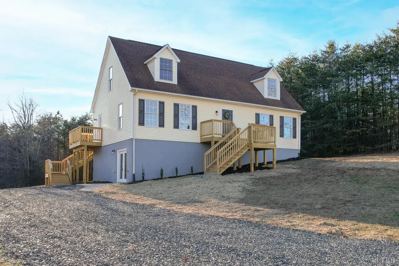 Side view of the Cape Cod with dormers and wood stairs at 188 Kiowa Road, Lynchburg VA