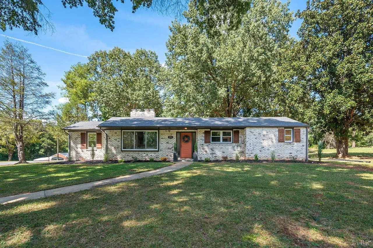 Front of the house, painted brick ranch with a long lawn and shade trees at 1912 Lakeside Drive, Lynchburg VA