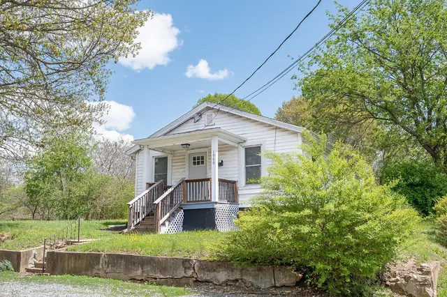 Front of the house with a covered porch and railing on a sloped lot at 1980 Easley Avenue, Lynchburg VA