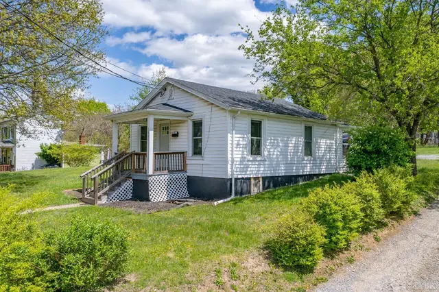 Side view of the house with a covered porch, steps and shrubs at 1980 Easley Avenue, Lynchburg VA