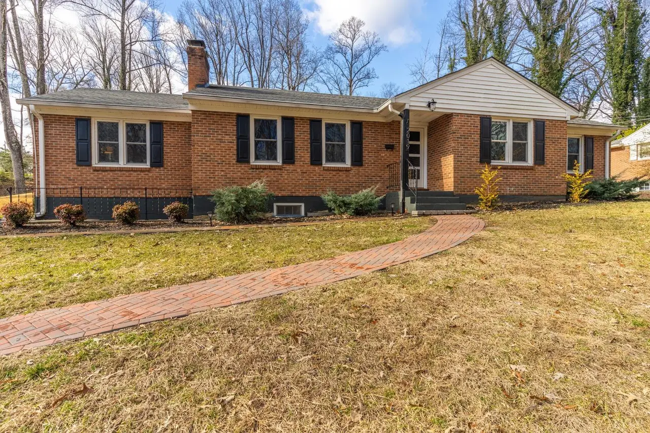 Front of the house, brick ranch with black shutters and a brick walkway at 2019 Indian Hill Rd Road, Lynchburg VA
