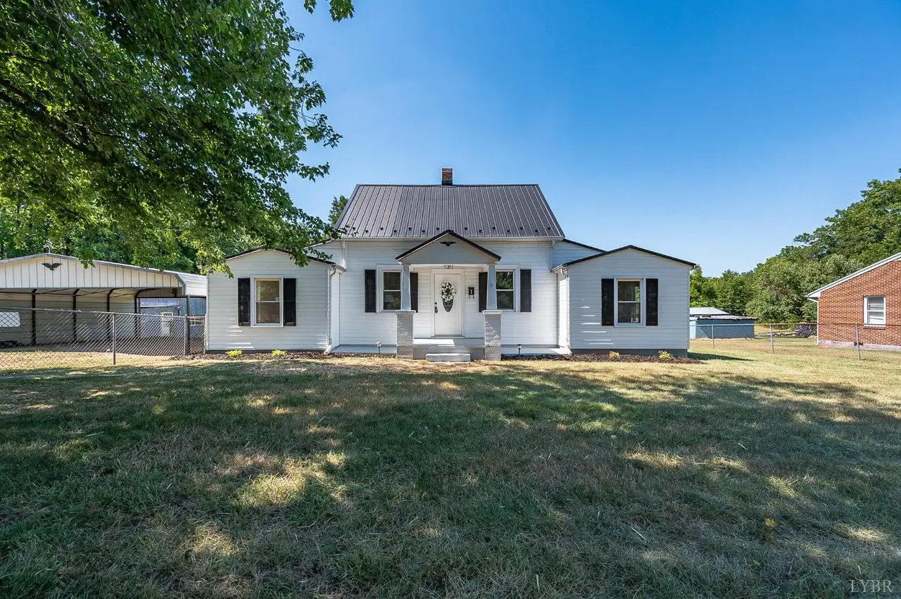 Front of the house, white with a metal roof and a carport beside it at 202 Longview Road, Hurt VA