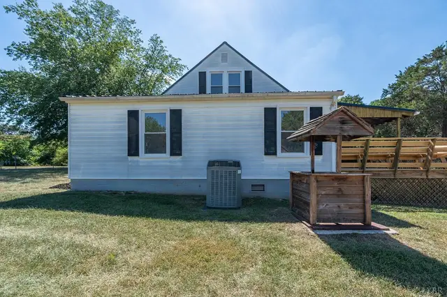 Back of the house with white siding and a wood privacy screen at 202 Longview Road, Hurt VA