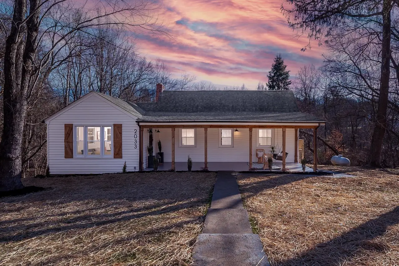 Front of the house with a long covered porch and a front walkway at sunset at 2033 Langhorne Road, Lynchburg VA