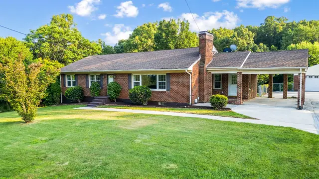 Front of the house, brick ranch with a chimney and an attached carport at 205 Statham Road, Lynchburg VA