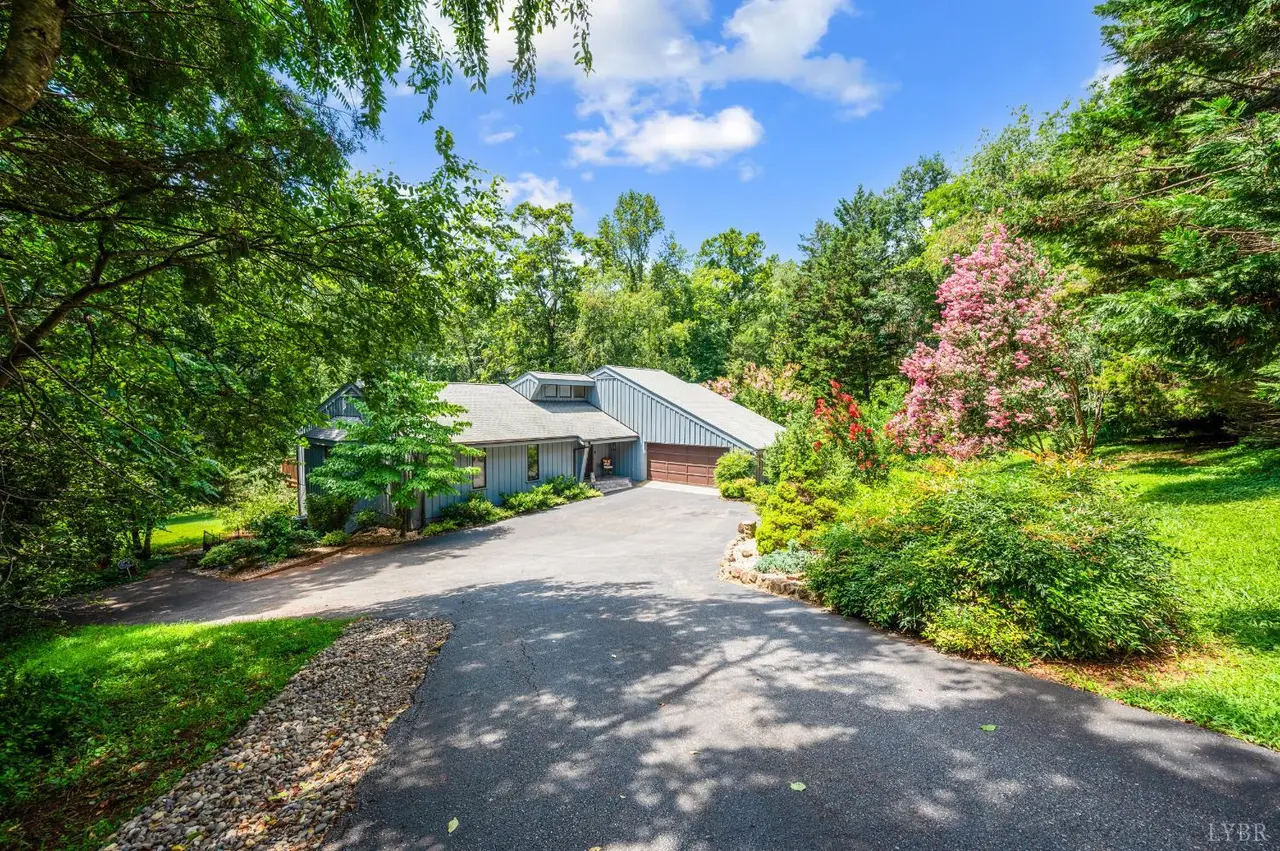 Paved driveway with flowering shrubs leading to the house at 210 Huntingwood Boulevard, Lynchburg VA