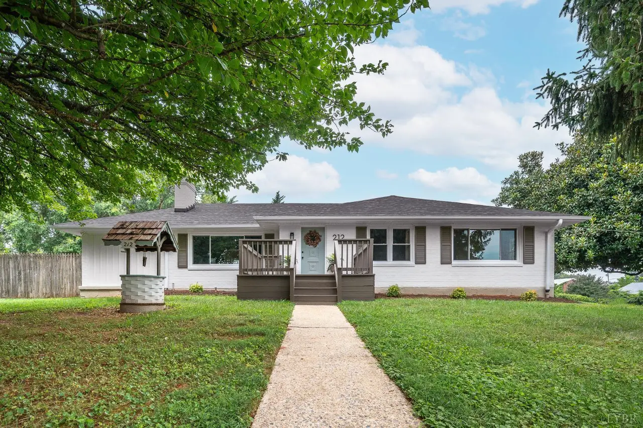 Front of the house, white ranch with a wishing well and a front walkway at 212 Roundelay Circle, Lynchburg VA