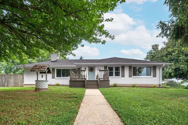 Front of the house, white ranch with a wishing well and a front walkway at 212 Roundelay Circle, Lynchburg VA
