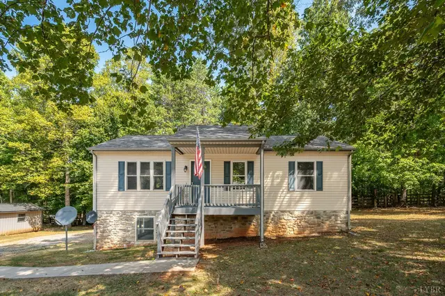 Front of the house with a covered porch, stone foundation and front steps at 2120 Eagle Point Road, Huddleston VA