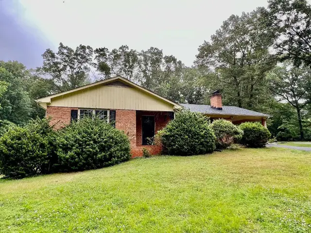 Front of the house, brick ranch with a cream gable and shrubs at 214 Blue Ridge Lane, Amherst VA