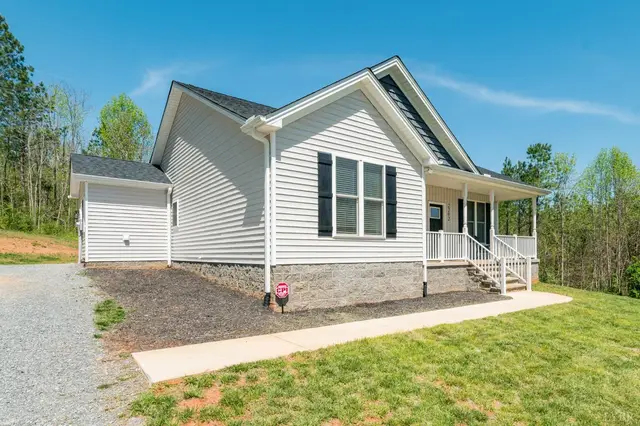 Side view of the house with a covered porch and a gravel driveway at 2292 Wheeler Road, Lynchburg VA