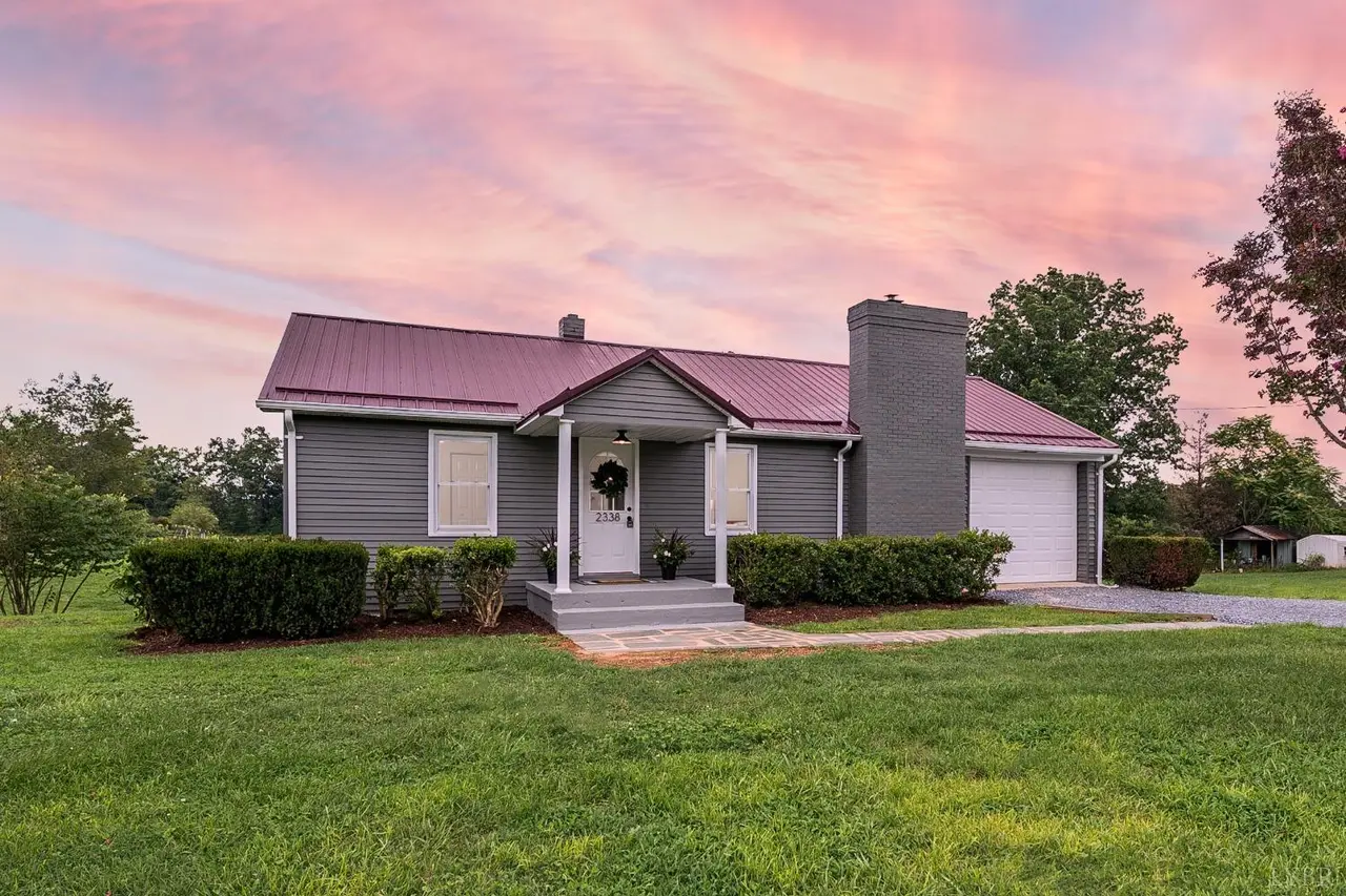 Front of the house, gray ranch with a metal roof and a garage at sunset at 2338 Railview Road, Gladys VA