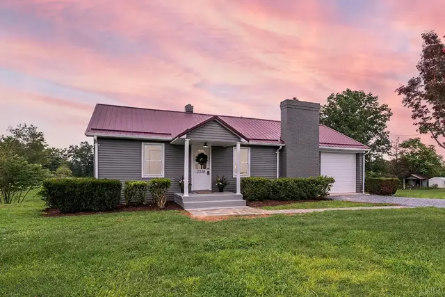 Front of the house, gray ranch with a metal roof and a garage at sunset at 2338 Railview Road, Gladys VA