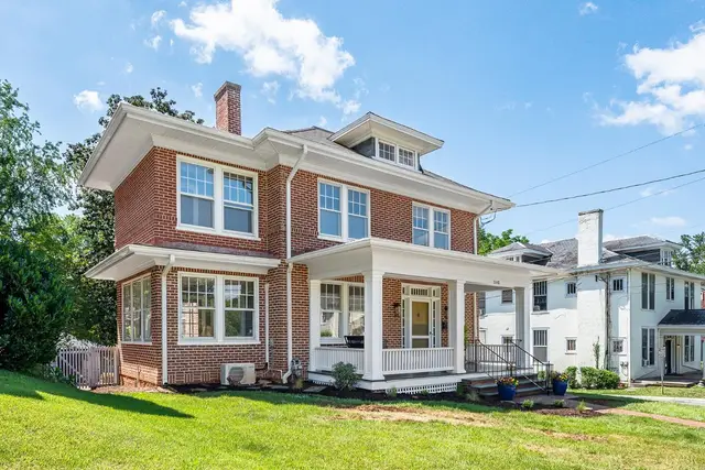 Front of the house from the side, brick with a hipped roof and front porch at 240 Warwick Lane, Lynchburg VA