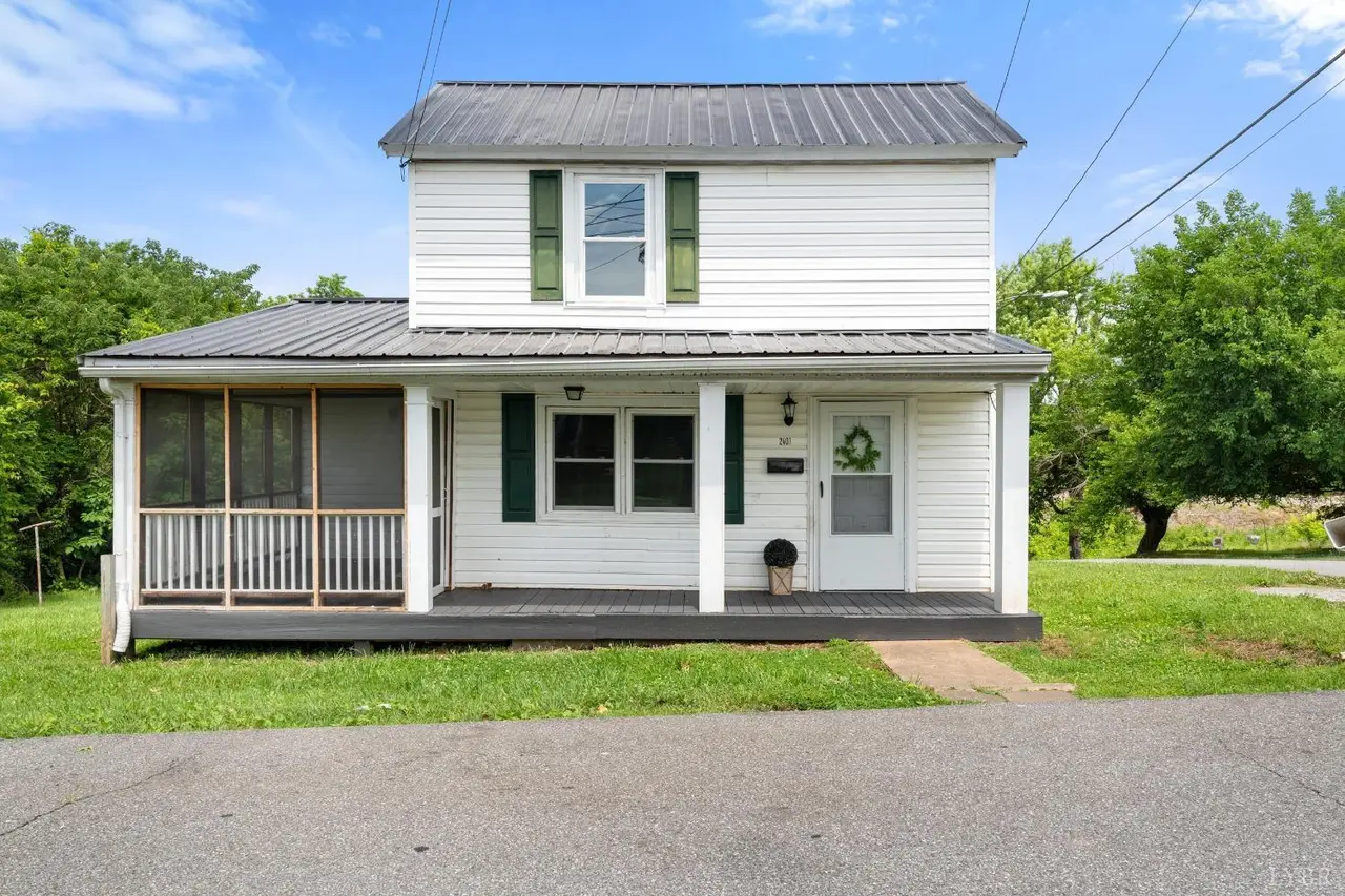 Front of the house, white two-story with a metal roof and screened porch at 2401 Otey Street, Lynchburg VA