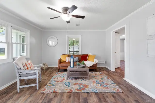 Living room with a ceiling fan, wood-look floors and a patterned rug at 2401 Otey Street, Lynchburg VA