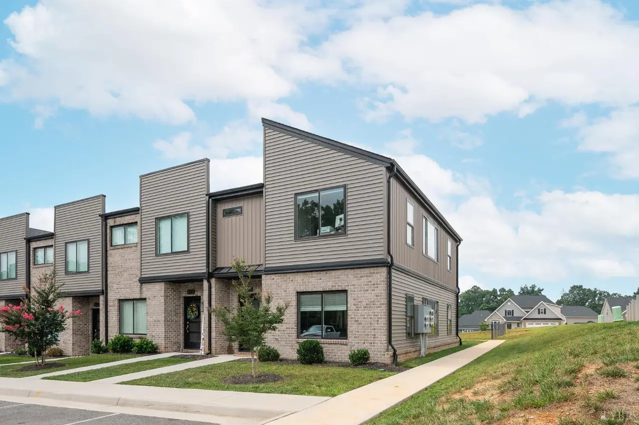 Front of the townhouses with modern siding, brick lower levels and walkways at 25 Zentry Pl, Lynchburg VA