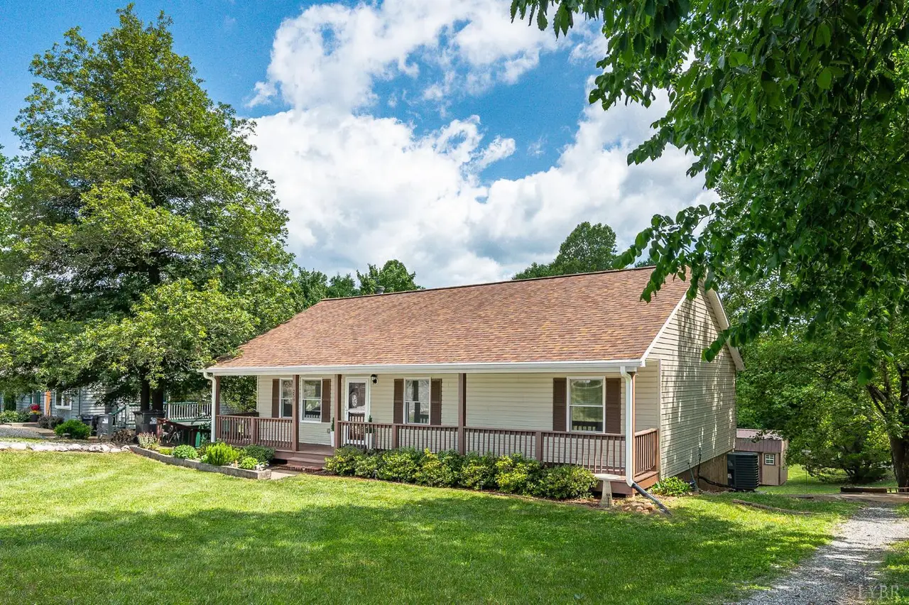 Front of the house, one-story with a long front porch under shade trees at 259 Crescent Lane, Monroe VA