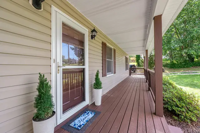 Covered front porch with a wood floor and a storm door at 259 Crescent Lane, Monroe VA