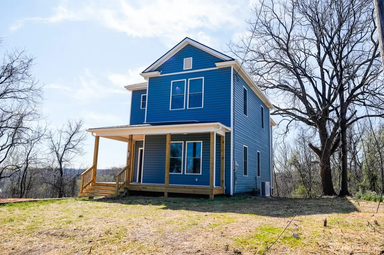 Front of the house, blue two-story with a wood front porch at 2611 Dudley Street, Lynchburg VA
