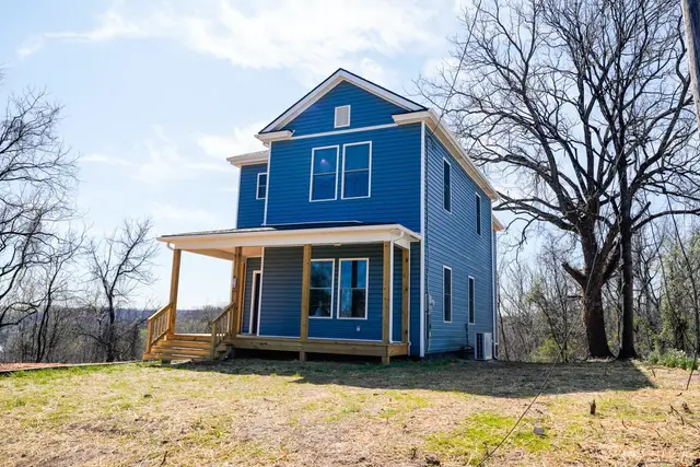 Front of the house, blue two-story with a wood front porch at 2611 Dudley Street, Lynchburg VA