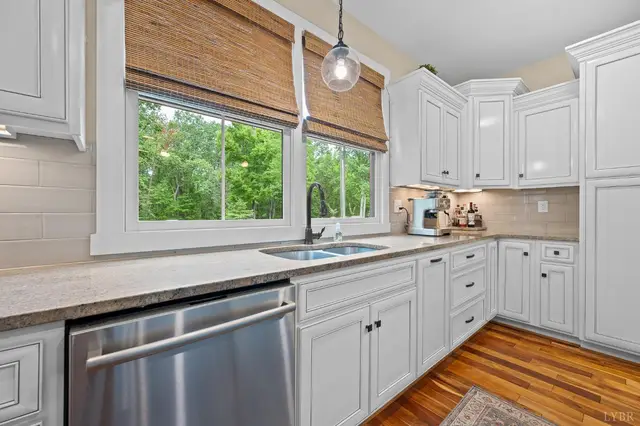 Kitchen sink under a window with bamboo shades at 2842 Chilton Road, Appomattox VA