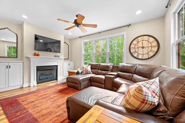 Living room with a gas fireplace and leather sectional at 2842 Chilton Road, Appomattox VA