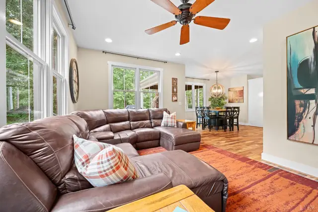 Living room with a leather sectional looking into the dining area at 2842 Chilton Road, Appomattox VA