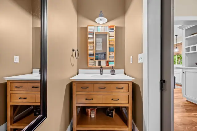 Bathroom with a wood vanity and colorful framed mirror at 2842 Chilton Road, Appomattox VA