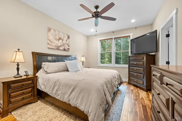 Bedroom with a ceiling fan and dark wood furniture at 2842 Chilton Road, Appomattox VA