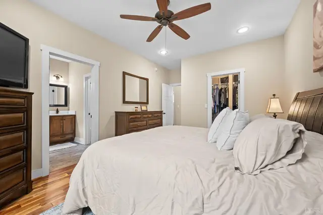 Bedroom with a sleigh bed and a view into the bathroom at 2842 Chilton Road, Appomattox VA