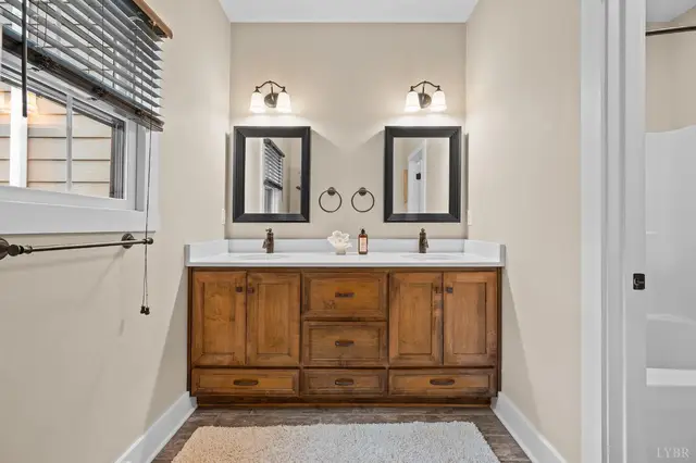 Bathroom with a double wood vanity and two mirrors at 2842 Chilton Road, Appomattox VA