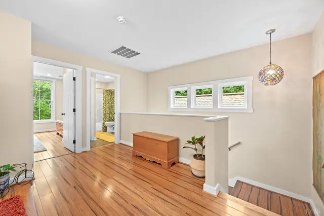 Upstairs landing with a pendant light and wood floors at 2842 Chilton Road, Appomattox VA