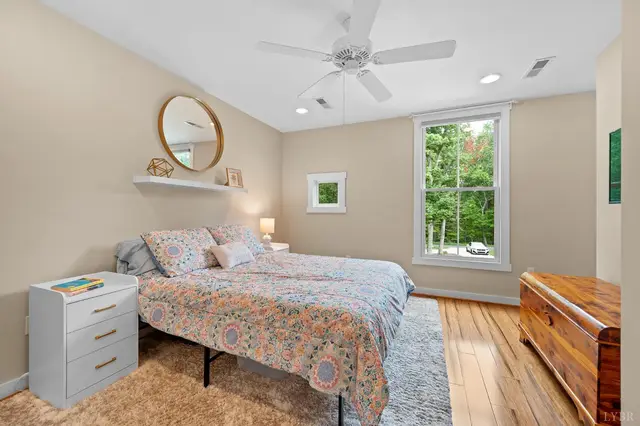 Bedroom with a round mirror and ceiling fan at 2842 Chilton Road, Appomattox VA
