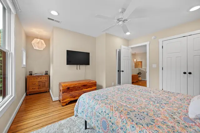 Bedroom with a wall-mounted TV and double closet doors at 2842 Chilton Road, Appomattox VA