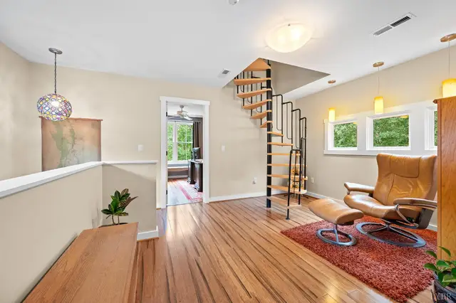 Loft with a spiral staircase and wood floors at 2842 Chilton Road, Appomattox VA
