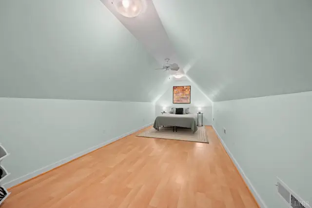 Attic bedroom with sloped ceilings and wood floors at 2842 Chilton Road, Appomattox VA