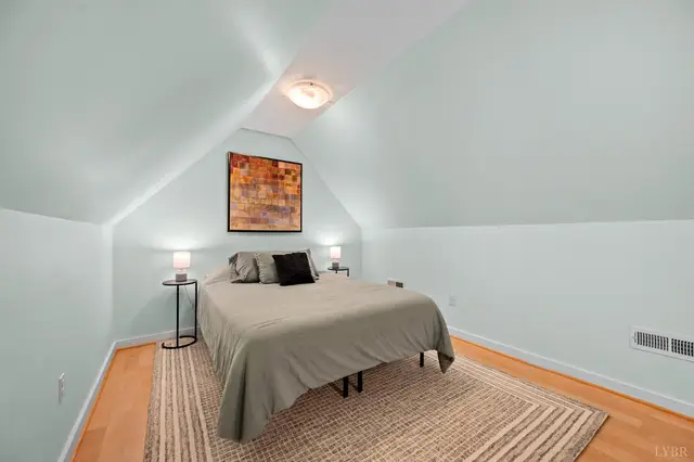 Bedroom with sloped ceilings and a woven rug at 2842 Chilton Road, Appomattox VA