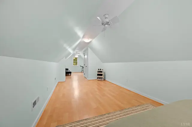 Attic room with sloped ceilings and a ceiling fan at 2842 Chilton Road, Appomattox VA