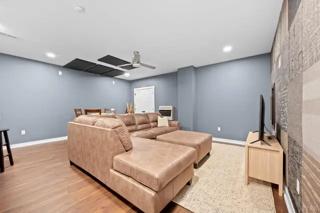 Basement family room with gray walls and a sectional sofa at 2842 Chilton Road, Appomattox VA